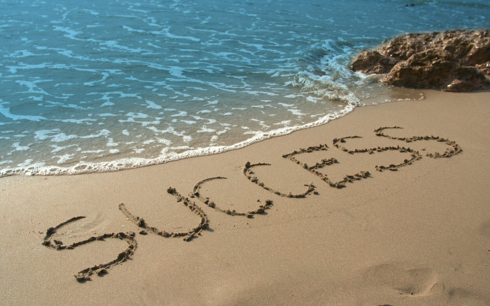 SUCCESS inscription in sand